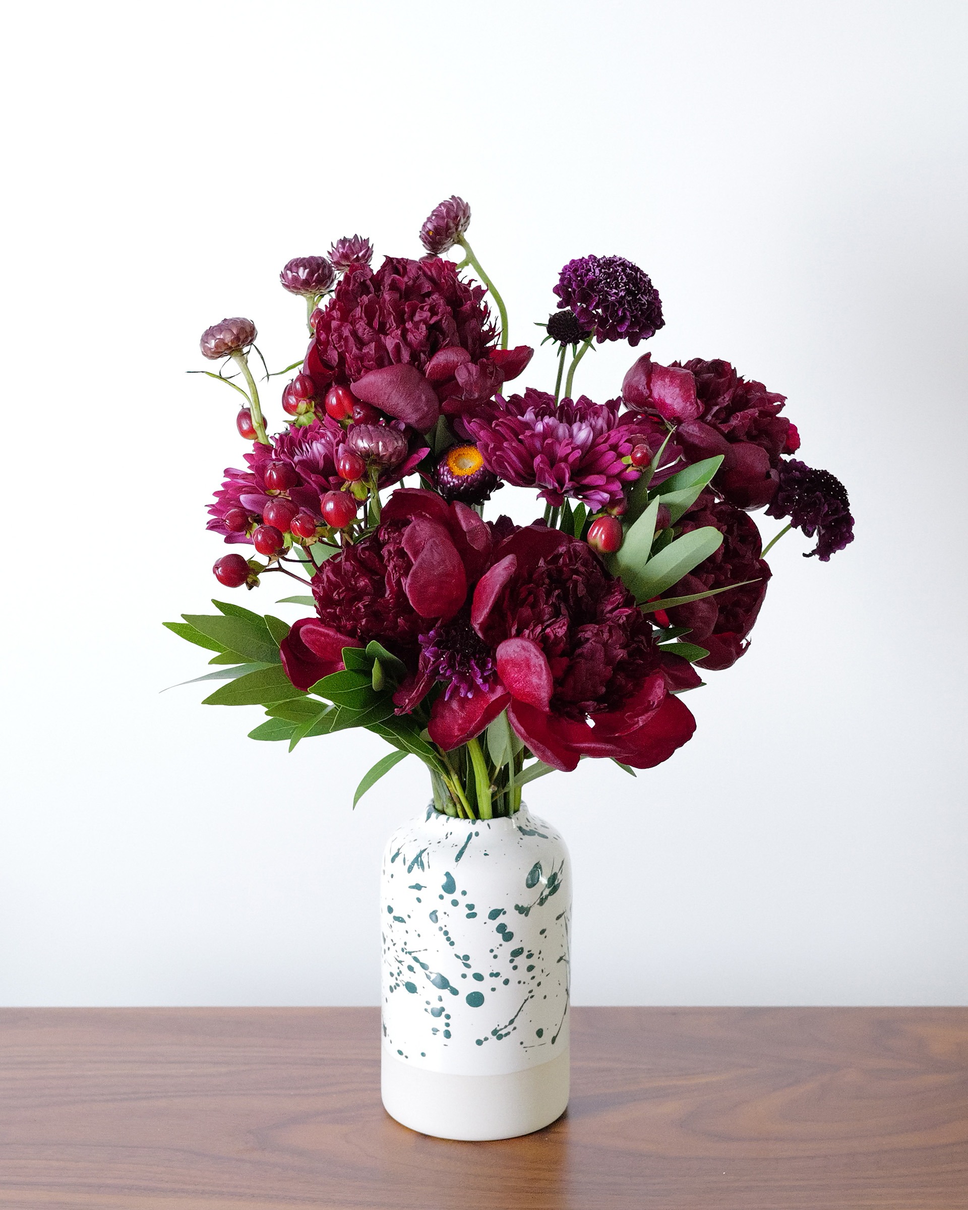 Deep red, magenta, plum, and red flower arrangement