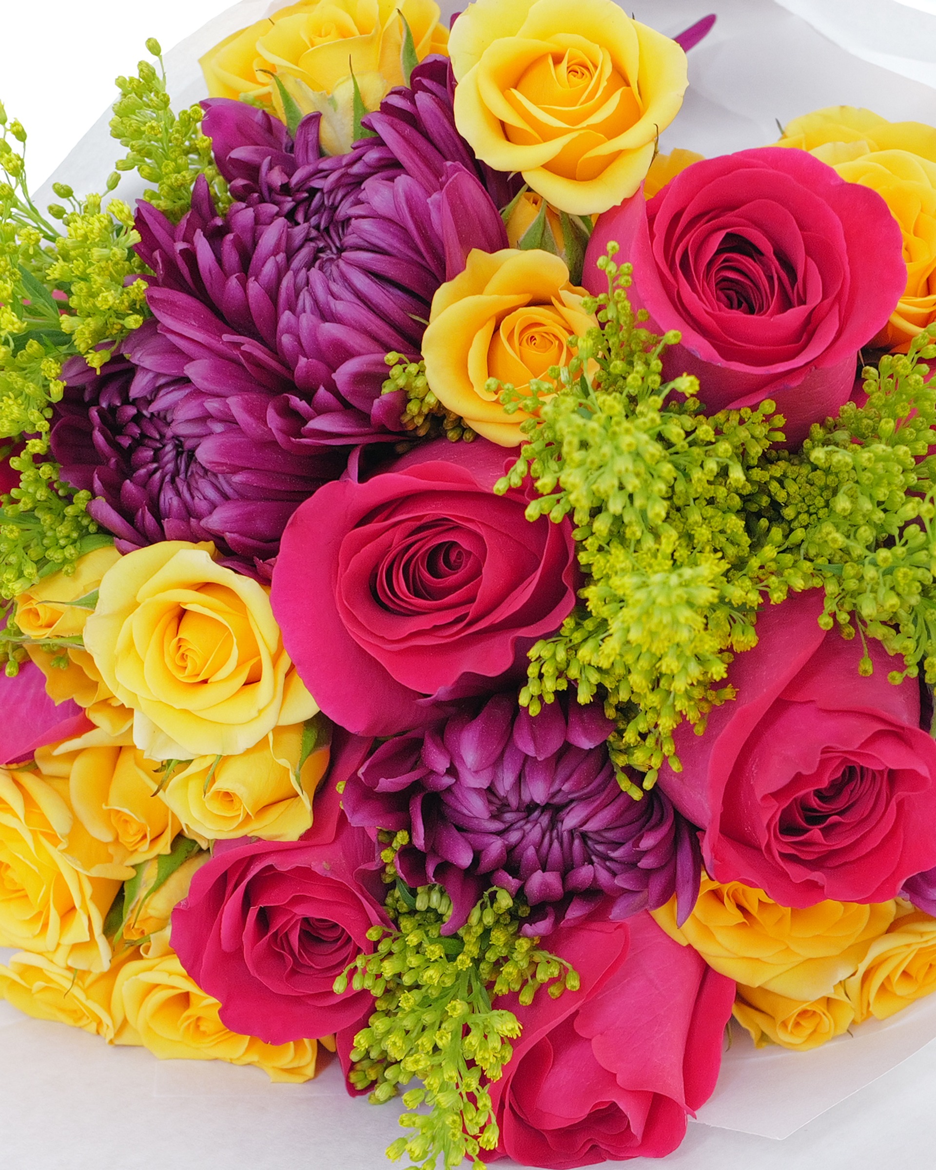Close-up of hot pink roses, purple chrysanthemums, yellow roses and yellow-green filler wrapped in white paper